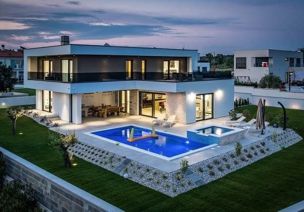 White villa with a palm-lined swimming pool